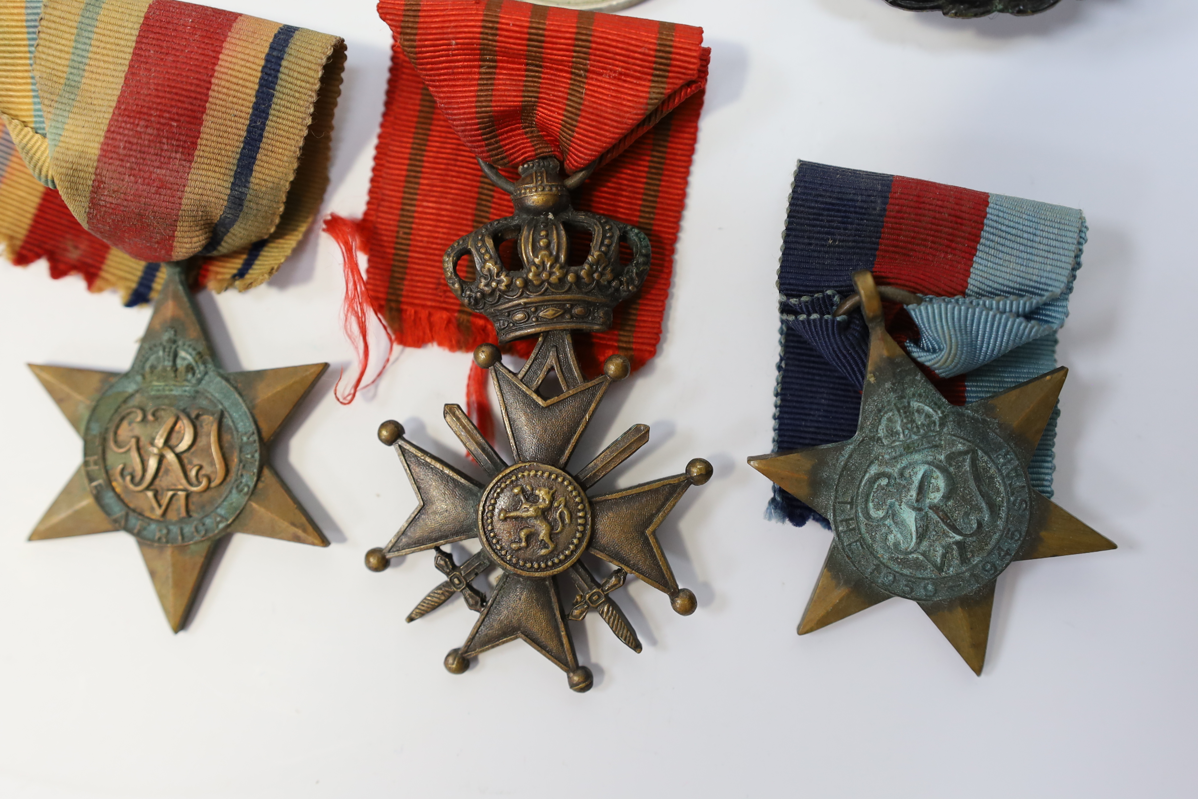 Seven medals including; a First World War British War Medal awarded to PTE. H. Lee DURH. L.I., A 1939-1945 medal, The Defence Medal, the Africa Star, the France and Germany Star, the 1939-1945 Star, plus a GPO cap badge.